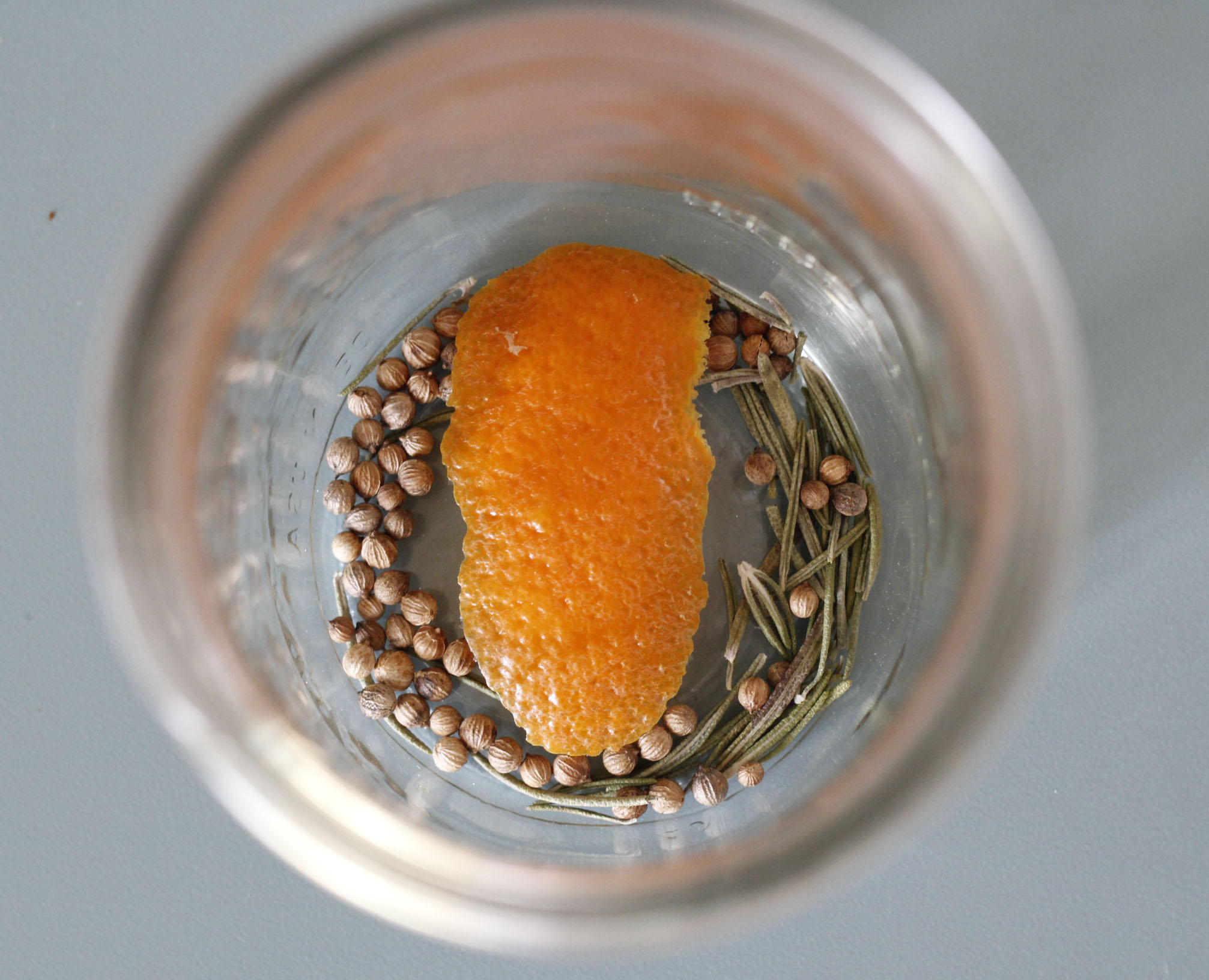 Rosemary, coriander, and orange peels in a Mason Jar for pickling Kohlrabi. 
