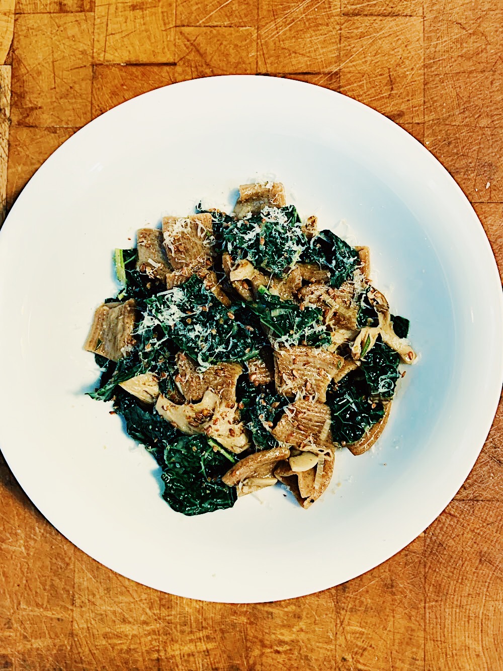 Overhead view of Pasta with Lacinato Kale, Maitake Mushrooms, & Flax Seed. Vegetables grown at Taproot Farm, PA. Recipe by Michael Joyce.