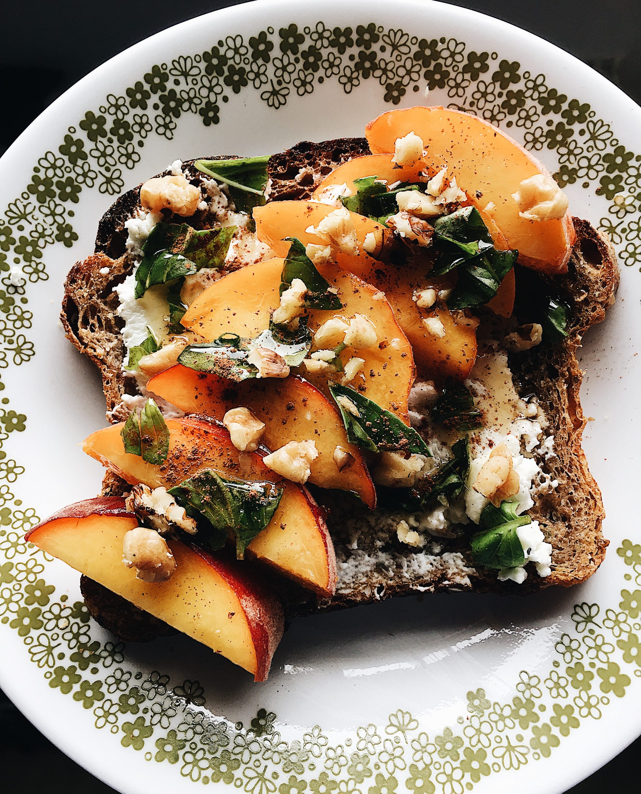An overhead view of Basil, Peach and Goat Cheese Toast. Recipe by Alysha Melnyk with Taproot Farm, PA.