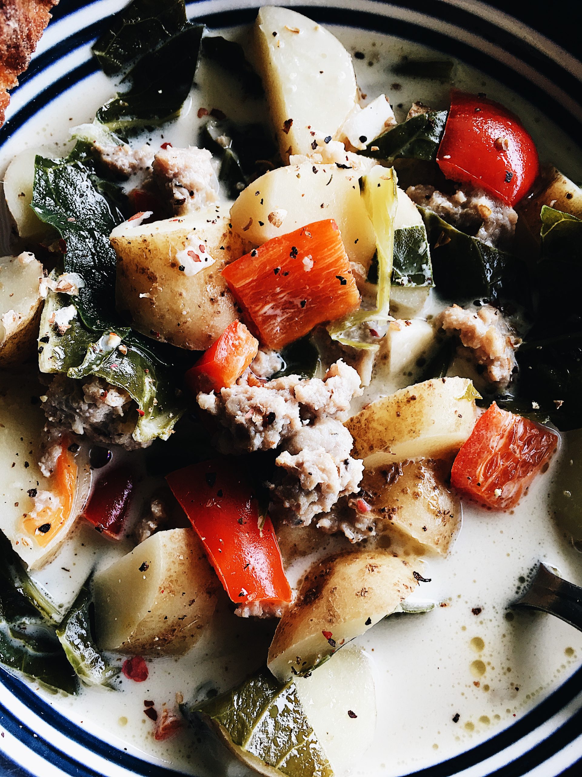 Detail shot of Collard Greens, Sweet Sausage, Pepper and Potato Soup. Recipe by Alysha Melnyk with Taproot Farm, PA.
