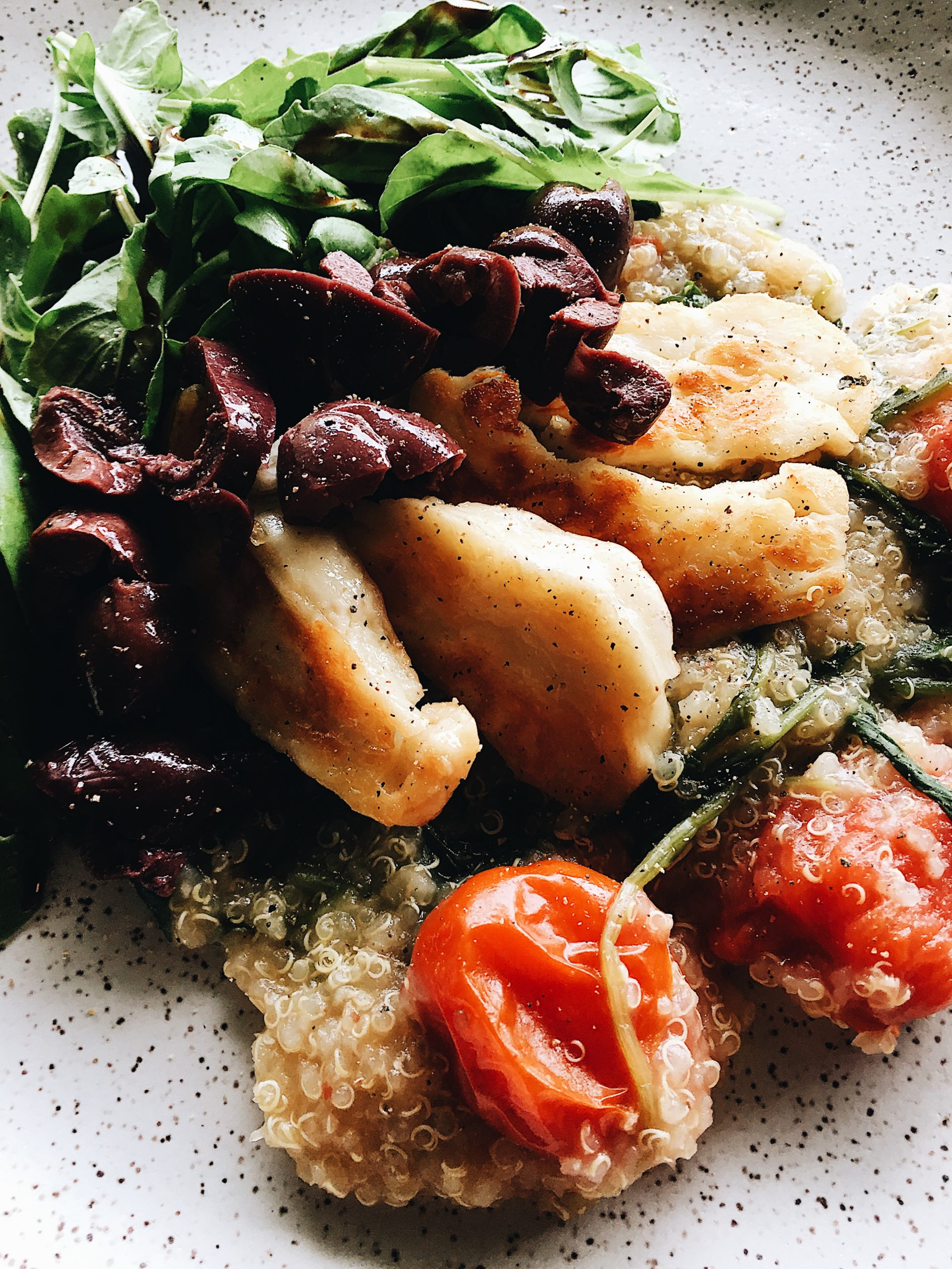 Detail shot of Mediterranean Quinoa with Tomatoes and Arugula. Recipe by Alysha Melnyk with Taproot Farm, PA.