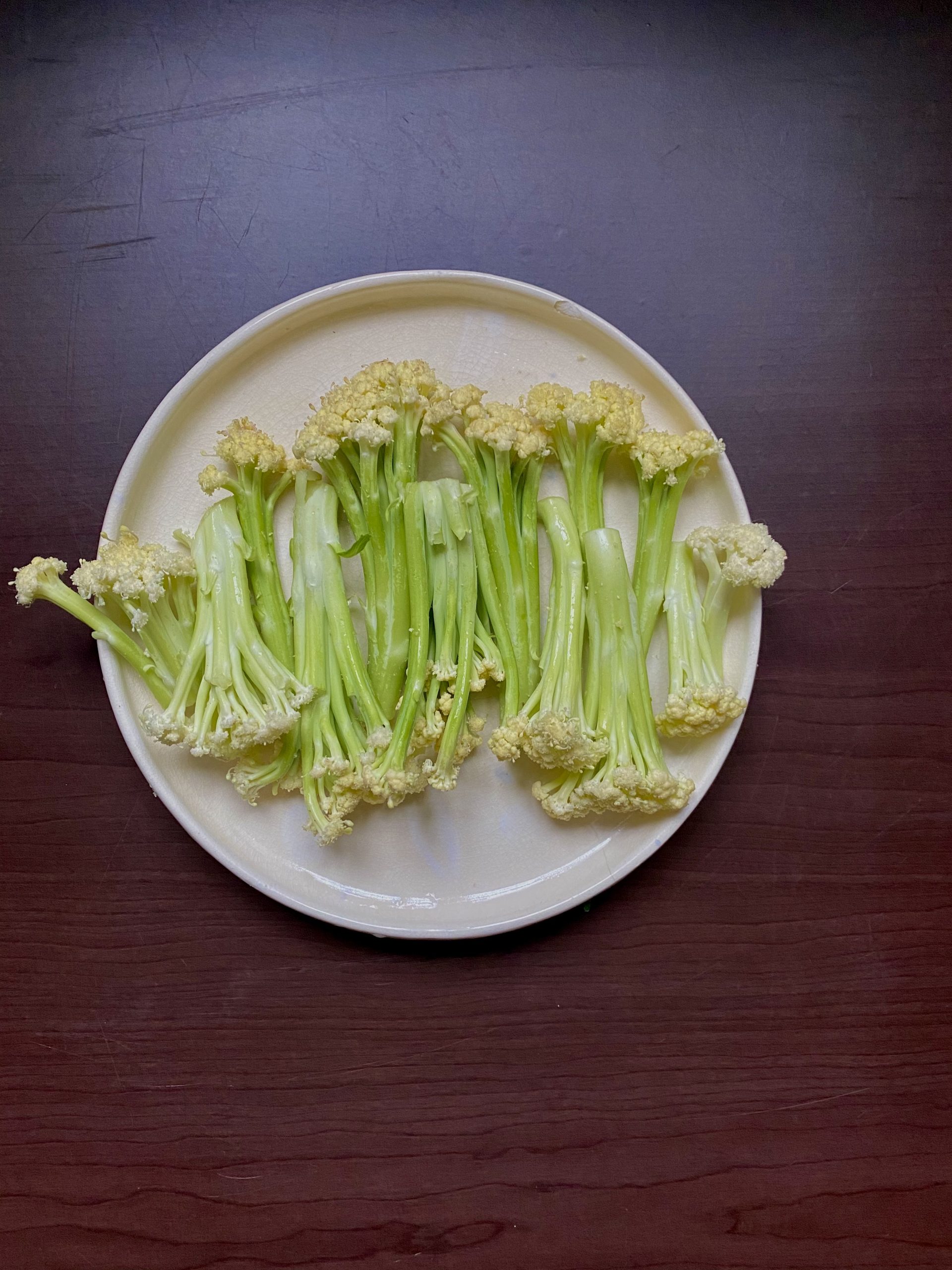 Flowering Cauliflower in the process of being plated to serve as an appetizer.