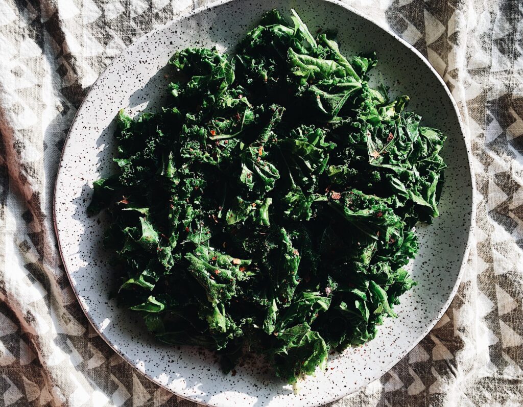 A large serving plate of braised kale, ready to eat.