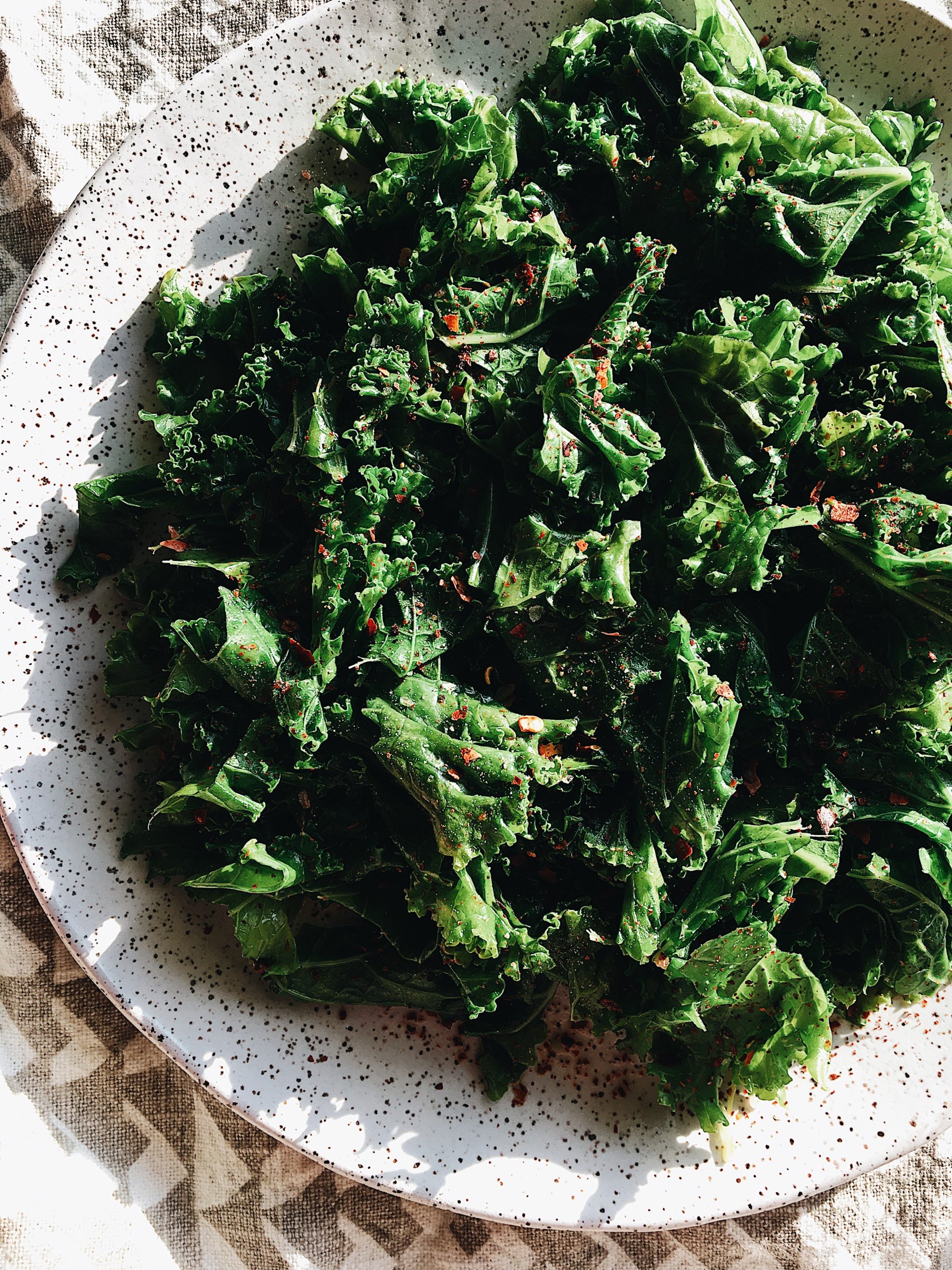 A close up view of braised kale with seasonings.