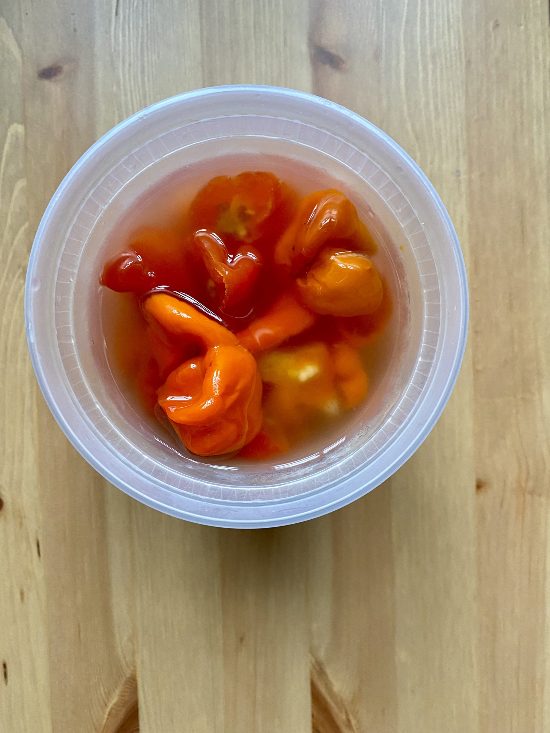 Close up view of pickled hot red peppers.